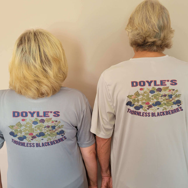 Two people wearing Doyle's Thornless Blackberries T-shirts, showcasing the vibrant back design.